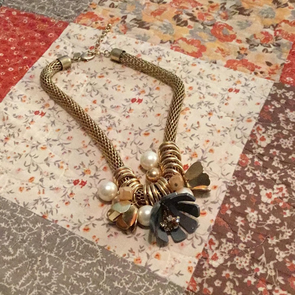 Gold colored and floral statement necklace.